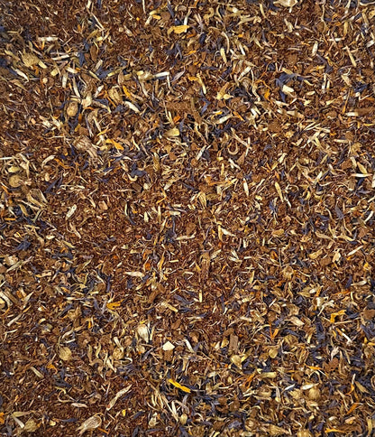 Close-up of dried herbs and flowers in brown, yellow, and purple, resembling organic teas.
