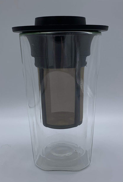 A clear glass coffee maker with black lid and mesh filter inside, designed for brewing organic coffees.