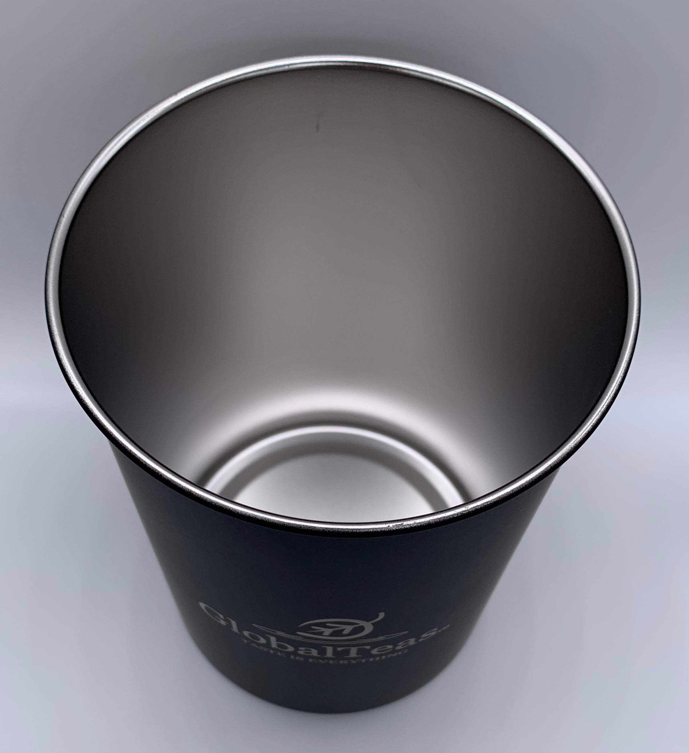 A sleek black metal cup featuring the logo of GlobalTeas, showcasing a polished interior and minimalistic design.